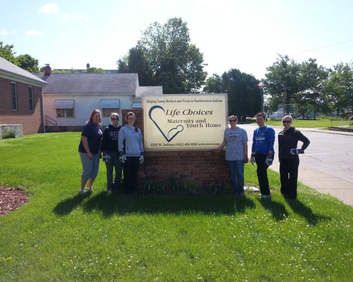 BSS CPA team standing by a non profit sign.